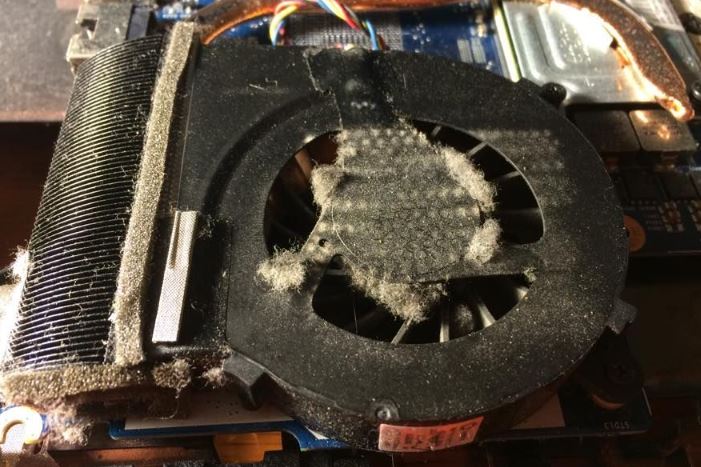 dust buildup inside gaming laptop fan causing poor airflow and overheating
